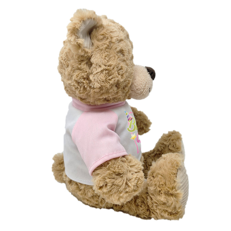 Side view of teddy bear plush wearing “Birthday Girl” shirt
