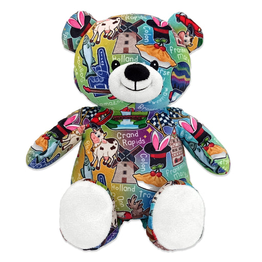 A multicolored teddy bear with a pattern of various city names and icons.