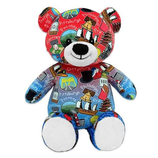 A multicolored teddy bear with printed city names and related icons, featuring a design specific to Pennsylvania.