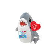 Plush shark toy with a 'Happy Valentine's Day' tag on a white background