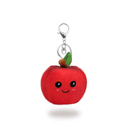 Front view of a red plush apple-shaped keychain with stitched smiling face, green leaf and brown stem on top, and a silver key ring clip, on a white background.