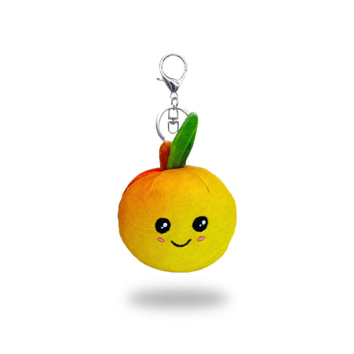 Front view of a yellow plush fruit keychain with a smiling face, green and orange felt leaves on top, and a silver metal keyring attached.