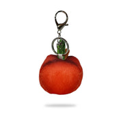 Top-back view of a red plush apple-shaped keychain with green leaf and brown stem attached to a silver key ring clip, on a white background.