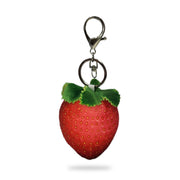 Back view of a plush strawberry keychain with red fabric, yellow seed details, green felt leaves on top, and a silver key ring clip, on a white background.