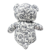 Back view of a white teddy bear plush covered in black Florida-themed illustrations, including alligators, dolphins, flamingos, suns, oranges, and the word Florida.