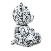 Side view of a black and white Georgia-themed teddy bear plush with bees, flowers, peaches, and “Georgia” text printed across the fabric, featuring “My name is” and “I was born on” text on the feet, on a white background.