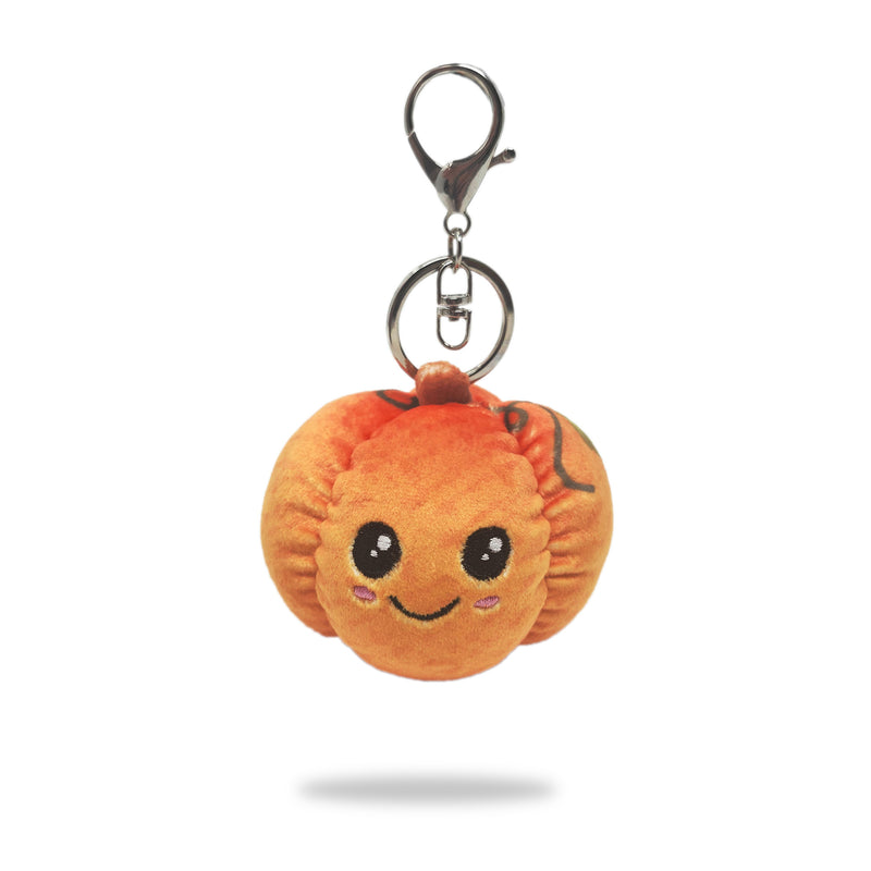 Front view of pumpkin plush keychain with smiling face