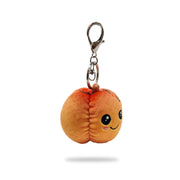 Angled side view of pumpkin plush keychain