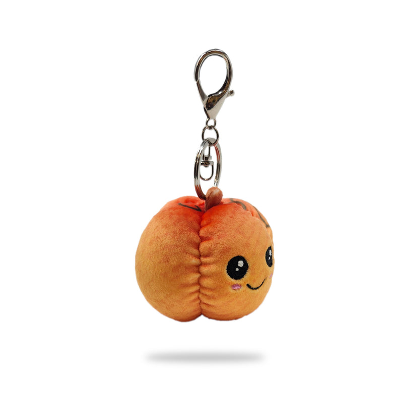 Angled side view of pumpkin plush keychain