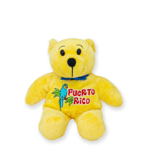Front view of a yellow plush teddy bear embroidered with “Puerto Rico” and a colorful parrot, wearing a blue bow tie on a white background.