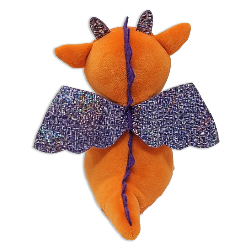 Back view of an orange plush dragon with purple stitched spine, pointed tail, small horns, ears, and wide glittery purple wings on a transparent background.
