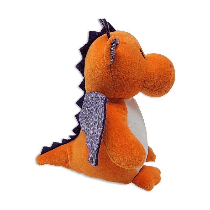 Side view of an orange plush dragon with white belly, purple wings, purple back spikes, small horns, and rounded snout on a transparent background.