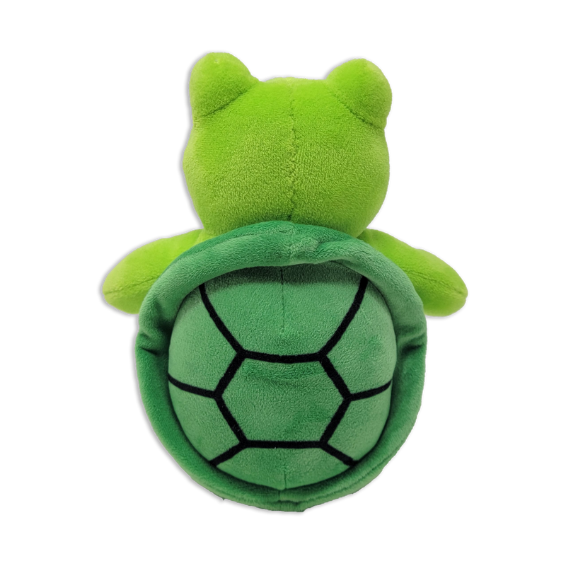 Back view of a green plush turtle showing a rounded head, small arms, and a darker green shell with black stitched hexagon pattern on a transparent background.