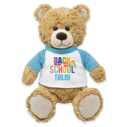 A brown plush teddy bear wearing a blue t-shirt with the text 'BACK TO SCHOOL TILLEY'.
