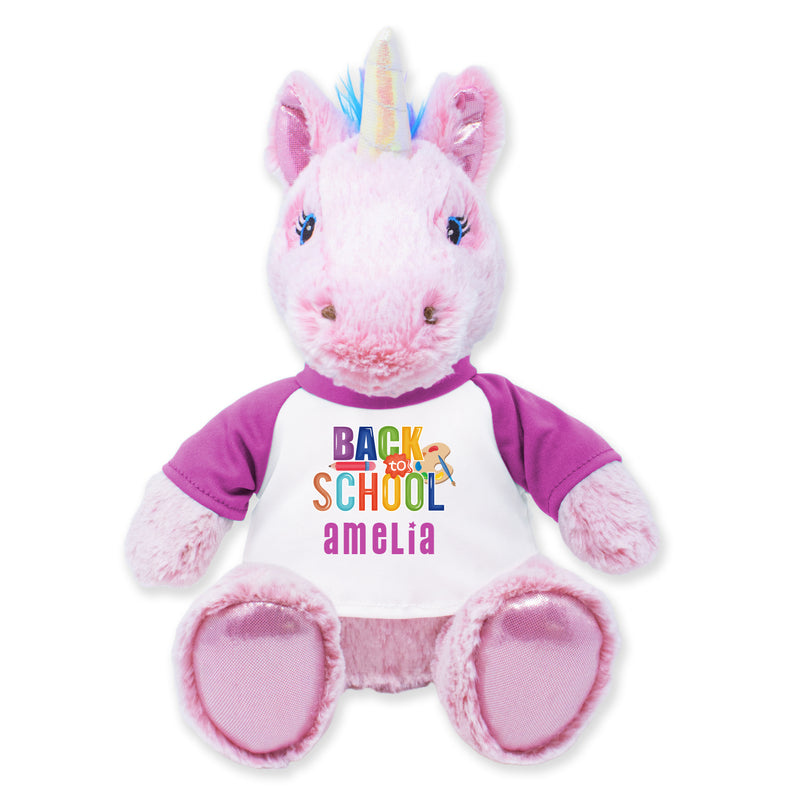 A 9-inch plush unicorn toy with a pink body, multicolored shirt, and a unicorn horn, designed for cuddling and as a decorative item.