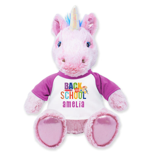 A 9-inch plush unicorn toy with a pink body, multicolored shirt, and a unicorn horn, designed for cuddling and as a decorative item.